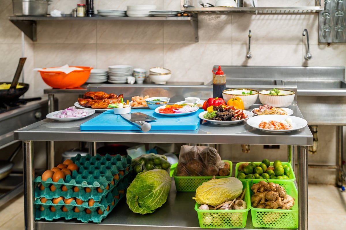 Kitchen counter filled with fresh ingredients prepared for service
