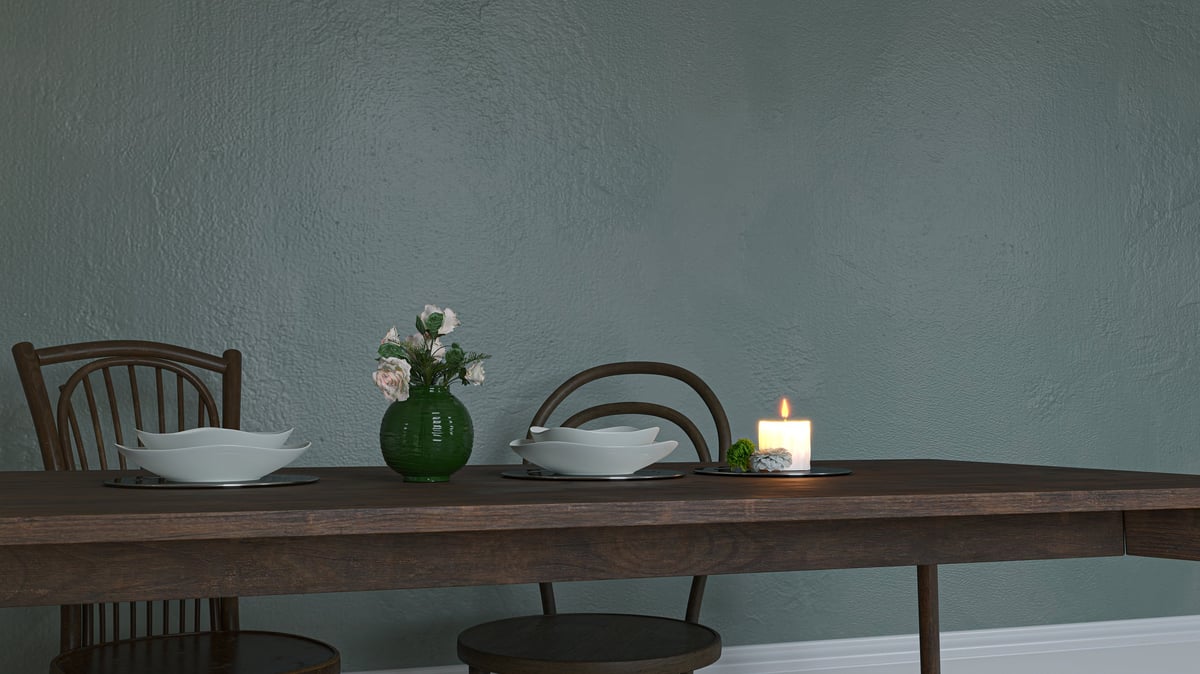 Dining room table set with bowls and candles, ready for guests